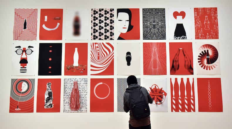 Posters on display at The Coca-Cola Bottle: An American Icon at 100 at The High Museum of Art running through Oct. 4. HYOSUB SHIN / HSHIN@AJC.COM