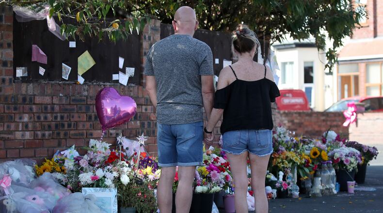 FILE - Floral tributes are left at the site in Southport, England, Aug. 11, 2024 after three young girls were killed in a knife attack at a Taylor Swift-themed holiday club. (AP Photo/Scott Heppell, File)