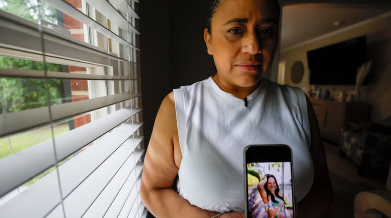 Ndahitha Cristobal, the mother of Ximena Arias-Cristobal, displays a photo of her daughter on her cellphone. Immigration authorities are currently holding Ximena after being wrongfully taken into custody on May 5. Even though the local police have dropped the charges against her, Ximena remains in immigration detention. (Miguel Martinez/AJC)