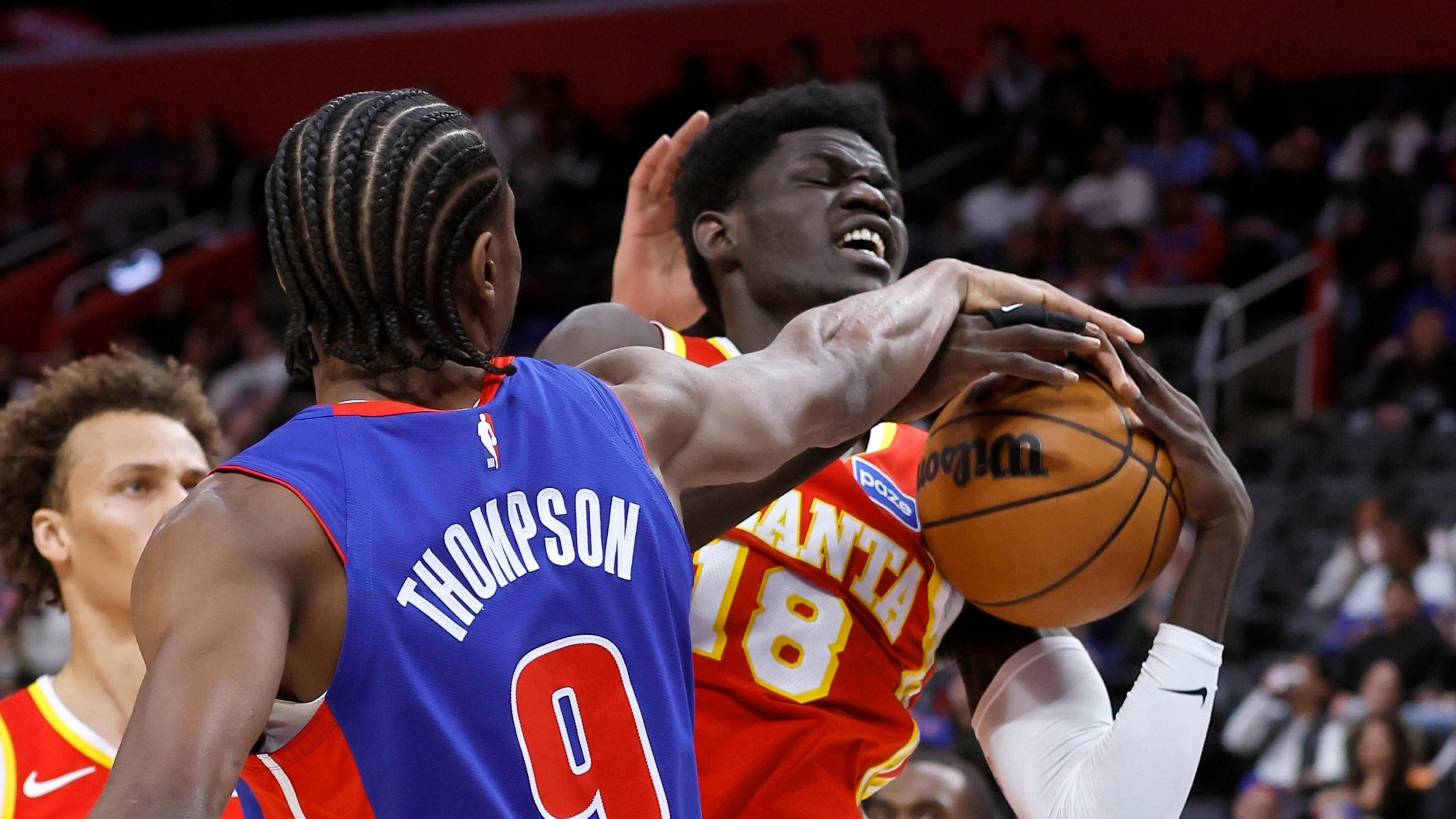 Atlanta Hawks forward Mouhamed Gueye (18) is defended by Detroit Pistons guard Ausar Thompson (9) while going to the basket during the first half of an NBA basketball game Friday, Dec. 12, 2025, in Detroit. (AP Photo/Duane Burleson)