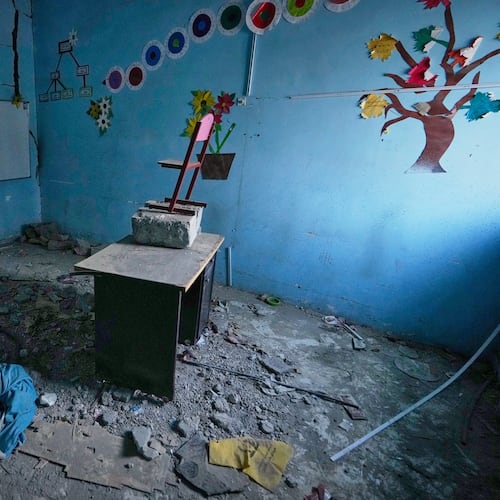 Colorful tree and flower decorations remain on the walls of a rubble-strewn classroom at Shajareh Tayyebeh school, damaged in a U.S. airstrike on Feb. 28, in Minab, southern Iran, Monday, Sept. 7, 2026. (AP Photo/Vahid Salemi)