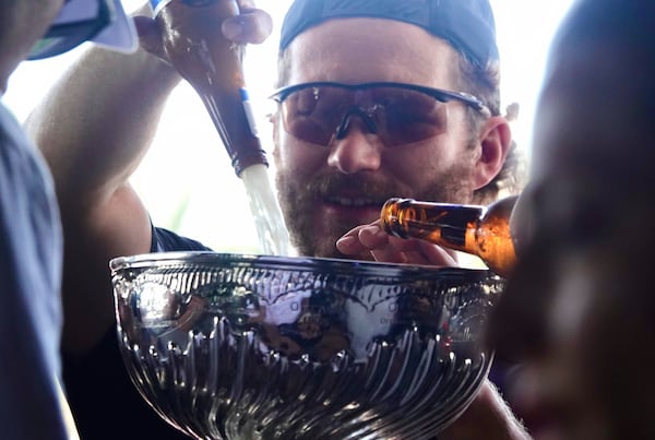 Florida Panthers left wing Matthew Tkachuk pours beer into the Stanley Cup at the Elbo Room at the Elbo Room, Wednesday, June 18, 2025, in Fort Lauderdale, Fla., the morning after defeating Edmonton in Game 6 of the Stanley Cup Final. (Joe Cavaretta/South Florida Sun-Sentinel via AP)