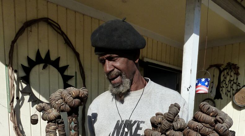 Mr. Imagination shows the three bottlecap staffs that survived the 2008 fire that leveled his home in Bethlehem, Penn.