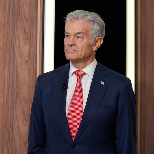Centers for Medicare & Medicaid Services administrator Dr. Mehmet Oz listens as President Donald Trump speaks about TrumpRx in the South Court Auditorium in the Old Eisenhower Executive Office Building on the White House campus, Thursday, Feb. 5, 2026, in Washington. (AP Photo/Alex Brandon)