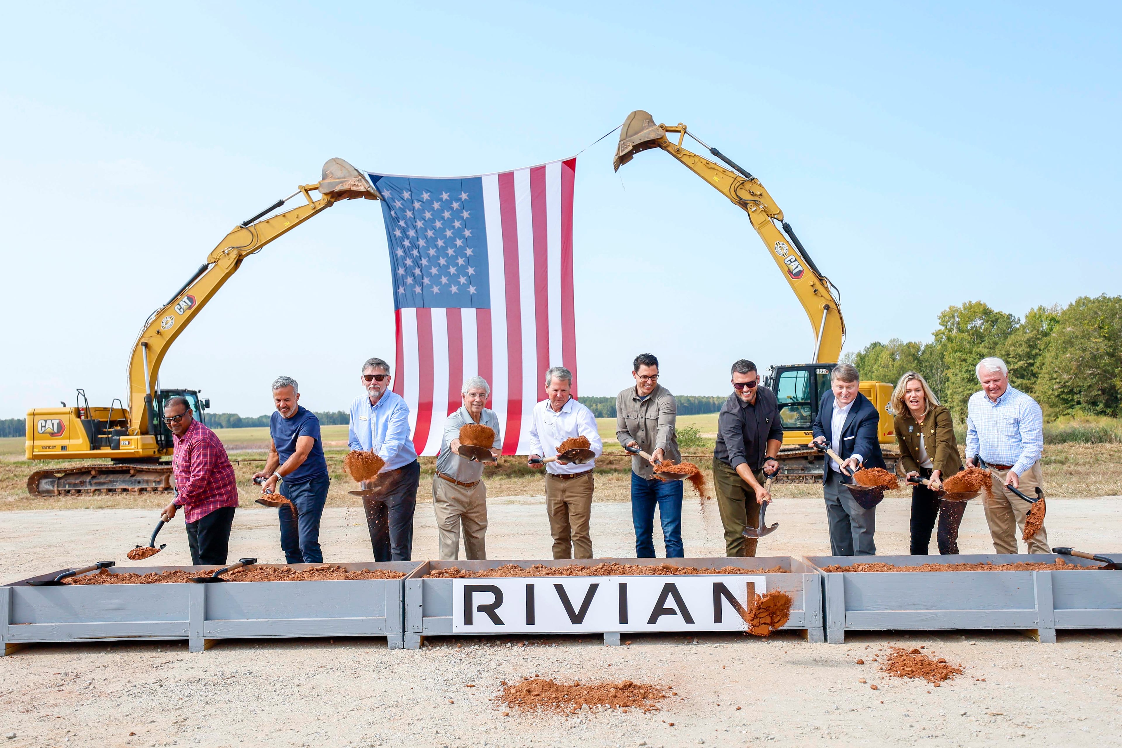 Rivian CEO RJ Scaringe, Georgia Gov. Brian Kemp, and Georgia House Speaker Jon Burns, along with a special guest, participate in the groundbreaking ceremony on Tuesday, Sept. 16, 2025, in Walton and Morgan counties. (Miguel Martinez/AJC)