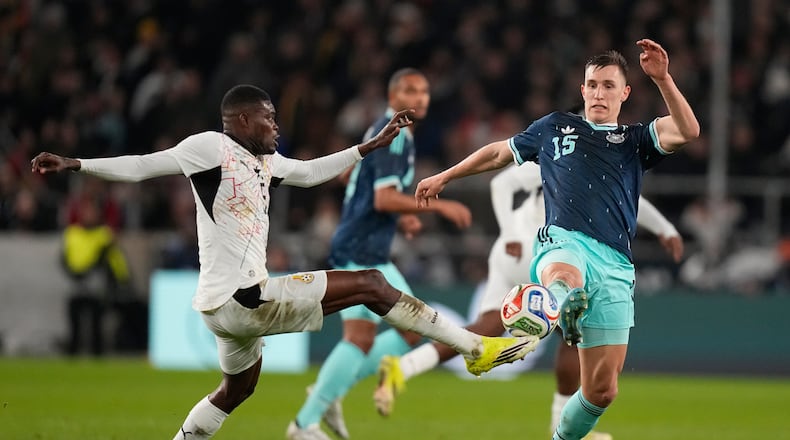 FILE -Thomas Partey of Ghana and Nico Schlotterbeck of Germany challenge for the ball during an international friendly soccer match between Germany and Ghana in Stuttgart, Germany, March 30, 2026. (AP Photo/Matthias Schrader, File)