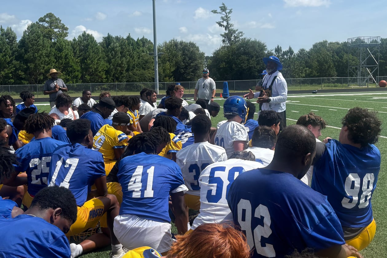 Brunswick football enters a new era under former Cook coach Byron Slack (center right, back). The Pirates are trying to move forward from a season-ending fight in the second round of the 2025 playoffs that led to more than 40 suspensions and a 2026 playoff ban. Most of the suspensions and the ban were later repealed. (Jack Leo/AJC)
