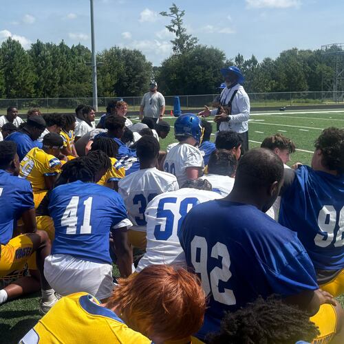 Brunswick football enters a new era under former Cook coach Byron Slack (center right, back). The Pirates are trying to move forward from a season-ending fight in the second round of the 2025 playoffs that led to more than 40 suspensions and a 2026 playoff ban. Most of the suspensions and the ban were later repealed. (Jack Leo/AJC)