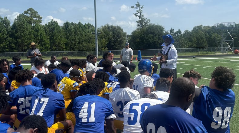 Brunswick football enters a new era under former Cook coach Byron Slack (center right, back). The Pirates are trying to move forward from a season-ending fight in the second round of the 2025 playoffs that led to more than 40 suspensions and a 2026 playoff ban. Most of the suspensions and the ban were later repealed. (Jack Leo/AJC)