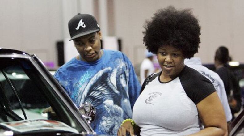 Jamal Evans & Trieva Brown check out a custom car at the V-103 Car and Bike show at the Georgia World Congress Center.