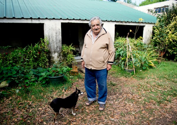 FILE - Uruguay's President Jose Mujica poses for a photo with his dog, Manuela, at his home on the outskirts of Montevideo, Uruguay, May 2, 2014. (AP Photo/Matilde Campodonico, File)
