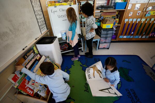 First grade students are seen participating in a class with an air purifier cleaning the air at Ashford Park Elementary School on Thursday, Nov. 2, 2023. (Miguel Martinez / miguel.martinezjimenez@ajc.com)