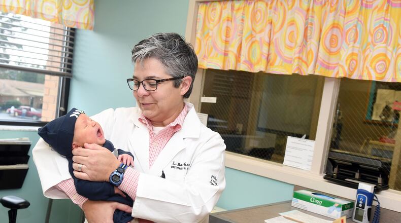 Dr. Lou Barker holds newborn, Noah Holland, at Dodge County Hospital in Eastman, Georgia on September 21, 2017. (Rebecca Breyer)