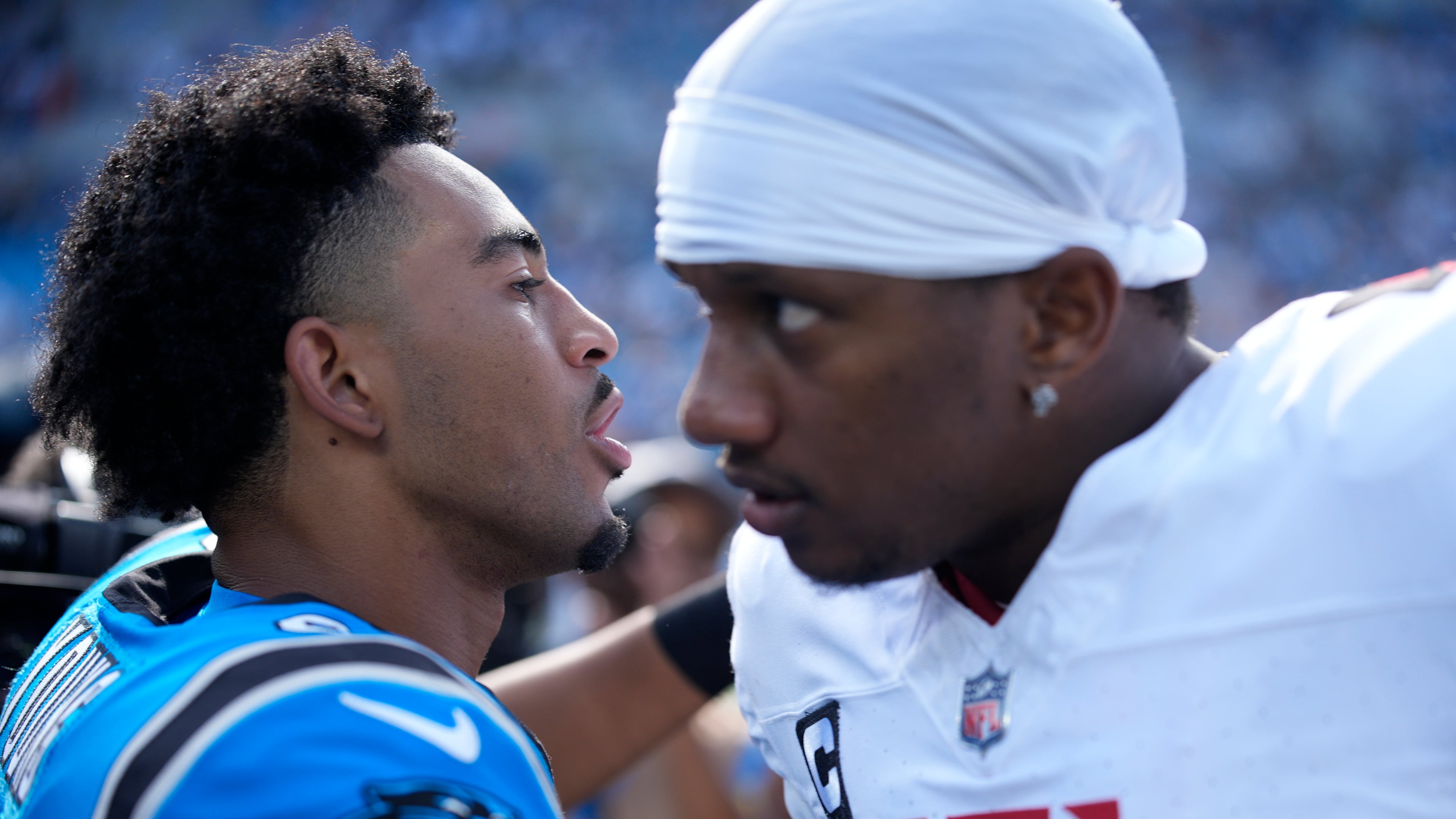 Panthers quarterback Bryce Young (left) and Falcons quarterback Michael Penix Jr. meet on the field following a game on Sunday, Sept. 21, 2025, in Charlotte, N.C. This Sunday's game brings the Panthers to Atlanta. (Jacob Kupferman/AP)