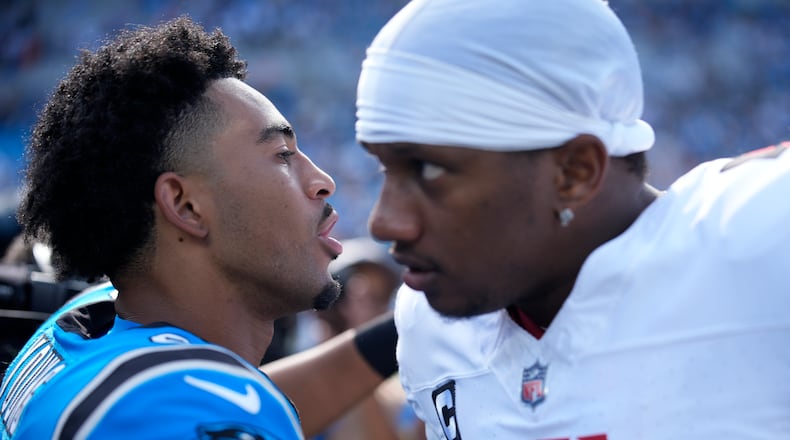 Panthers quarterback Bryce Young (left) and Falcons quarterback Michael Penix Jr. meet on the field following a game on Sunday, Sept. 21, 2025, in Charlotte, N.C. This Sunday's game brings the Panthers to Atlanta. (Jacob Kupferman/AP)