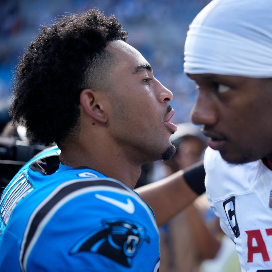 Panthers quarterback Bryce Young (left) and Falcons quarterback Michael Penix Jr. meet on the field following a game on Sunday, Sept. 21, 2025, in Charlotte, N.C. This Sunday's game brings the Panthers to Atlanta. (Jacob Kupferman/AP)