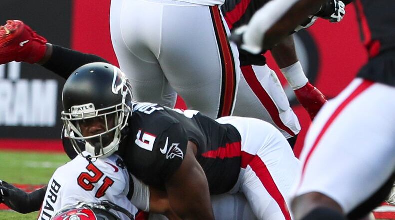 Tampa Bay Buccaneers quarterback Tom Brady (12) is sacked by Falcons defensive end Dante Fowler Jr. (6) as he fumbles the ball during the first half  Sunday, Sept. 19, 2021, at Raymond James Stadium in Tampa. (Dirk Shadd/Tampa Bay Times)