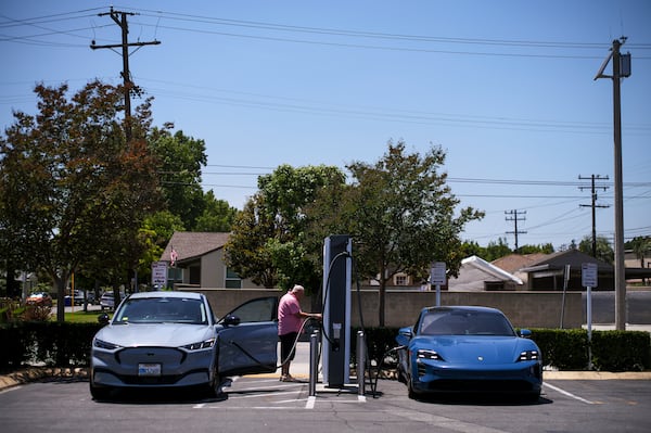 FILE - Electric vehicles charge at an Electrify America station in Arcadia, Calif., May 22, 2025. (AP Photo/Jae C. Hong, File)