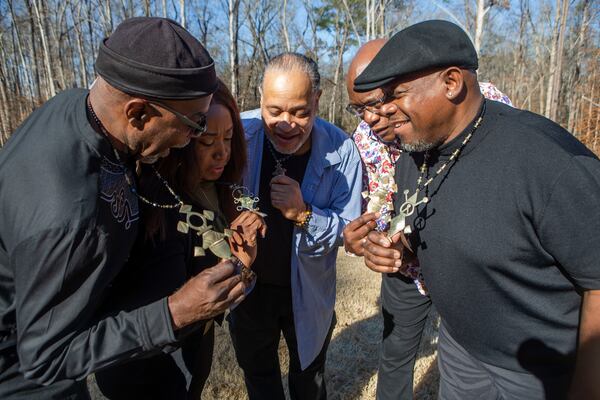 Siblings John Taylor (from left), Wanda Welcome, Tawala Kweli, Lewis Thompson and Percival Lammie show off their matching necklaces for a photo together during a family reunion on Wednesday, December 27, 2022, in Suwanee. At the event, Thompson, visiting from Australia, met four of his seven biological siblings for the first time. The necklaces are meant to represent family and tribal unity. CHRISTINA MATACOTTA FOR THE ATLANTA JOURNAL-CONSTITUTION. 
