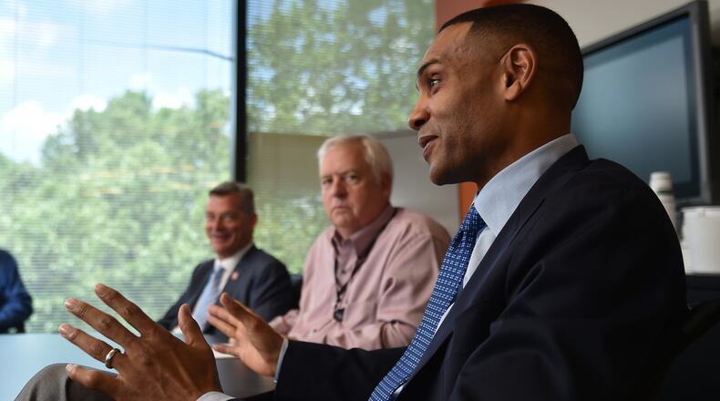 The Atlanta Hawks new principal owner Tony Ressler and partner Grant Hill, foreground, met with Atlanta Journal Constitution editors, managers and reporters Thursday June 25, 2015. AJC file photo