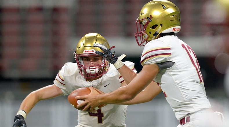 Brookwood QB Dylan Lonergan (12) hands the ball off to RB Eli Kohl (4) in the second half of their game at the Mercedes Benz Stadium in Atlanta during the Corky Kell Classic Saturday, August 24, 2019. PHOTO/Daniel Varnado