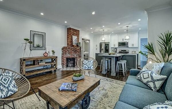 A charming, uniquely shaped fireplace in the den provides a unique accent.