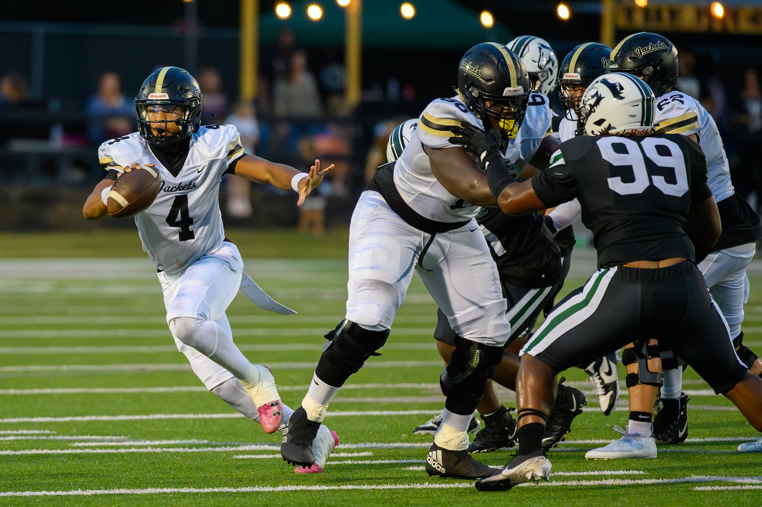 Sprayberry quarterback Jaden Duckett scrambles against the Kennesaw Mountain defense during Friday's game in Kennesaw. (Jamie Spaar for the Atlanta Journal Constitution)
