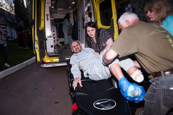 An injured Ukrainian soldier who was a prisoner of war is placed on a stretcher after being returned to his home country by Russia, April. 19, 2025. (AP Photo/Evgeniy Maloletka)