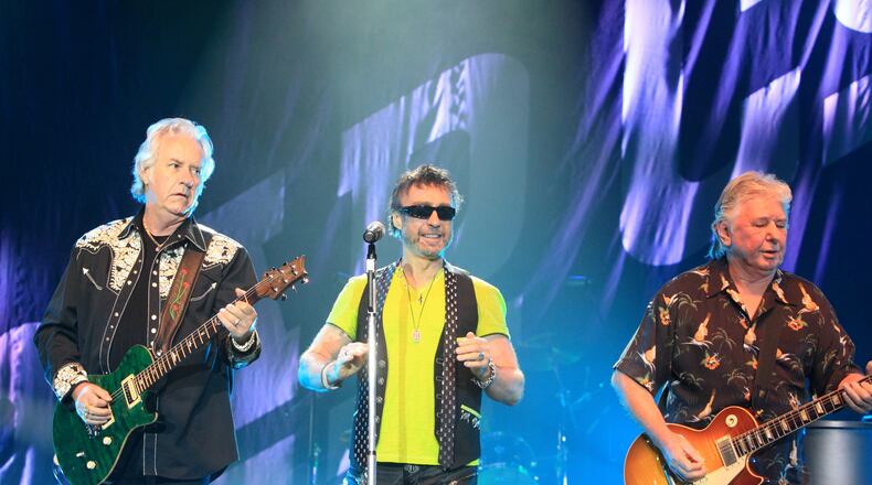 FILE - Howard Leese, from left, Paul Rodgers, and Mick Ralphs, of the classic rock band Bad Company, perform in Bethlehem, Pa., on July 29, 2013. (Photo by Owen Sweeney/Invision/AP, File)