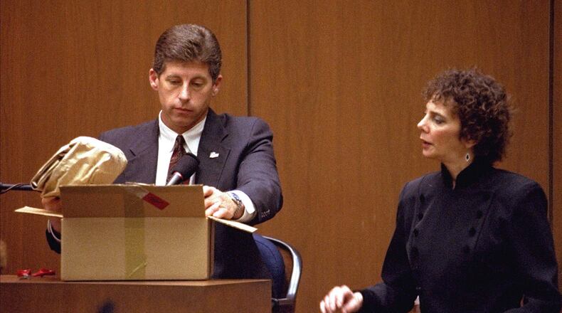 FILE - Los Angeles Police Detective Mark Fuhrman shows the jury in the O.J. Simpson double murder trial evidence during testimony Friday, March 10, 1995, in Los Angeles. (AP Photo/Nick Ut, Pool, File)