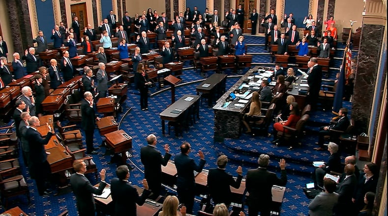 FILE - In this Jan. 16, 2020, image from video, presiding officer Supreme Court Chief Justice John Roberts swears in members of the Senate for the impeachment trial against President Donald Trump at the U.S. Capitol in Washington. No cell phones. No talking. No escape. One-hundred U.S. senators will soon be stationed at wooden desks, under the threat of imprisonment, as they silently listen to the arguments in the impeachment trial of President Donald Trump. While senators groan about the restrictions _ and will likely violate them at times _ they say the long-standing rules are crucial as they execute their most solemn duty: considering whether to remove the president of the United States. (Senate Television via AP, File)