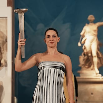 Actress Mary Mina playing the role of high priestess performs during the final rehearsal ahead of the flame lighting for the Milan Cortina 2026 Winter Olympics, at the archaeological museum of Olympia, Greece, Tuesday, Nov. 25, 2025. (AP Photo/Thanassis Stavrakis)