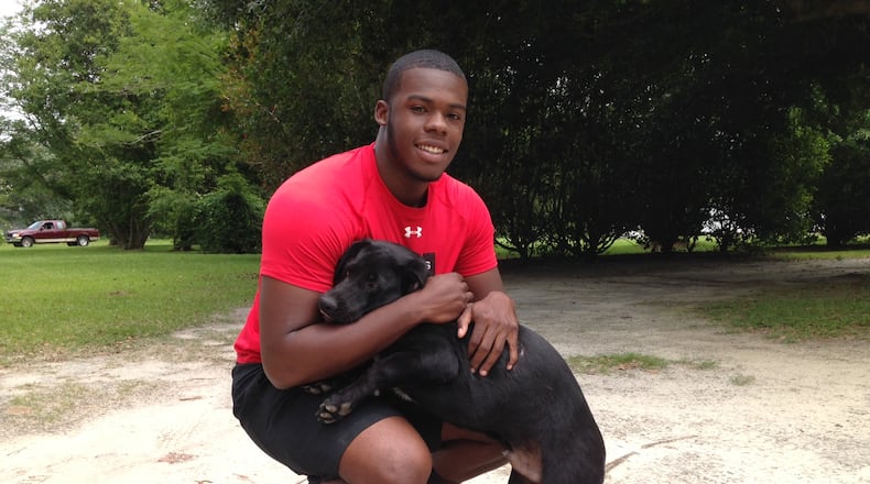 Georgia Tech incoming freshman punter Pressley Harvin III with his shorthaired Labrador Rocky at Harvin’s home in South Carolina on May 31, 2017. (AJC photo by Ken Sugiura)