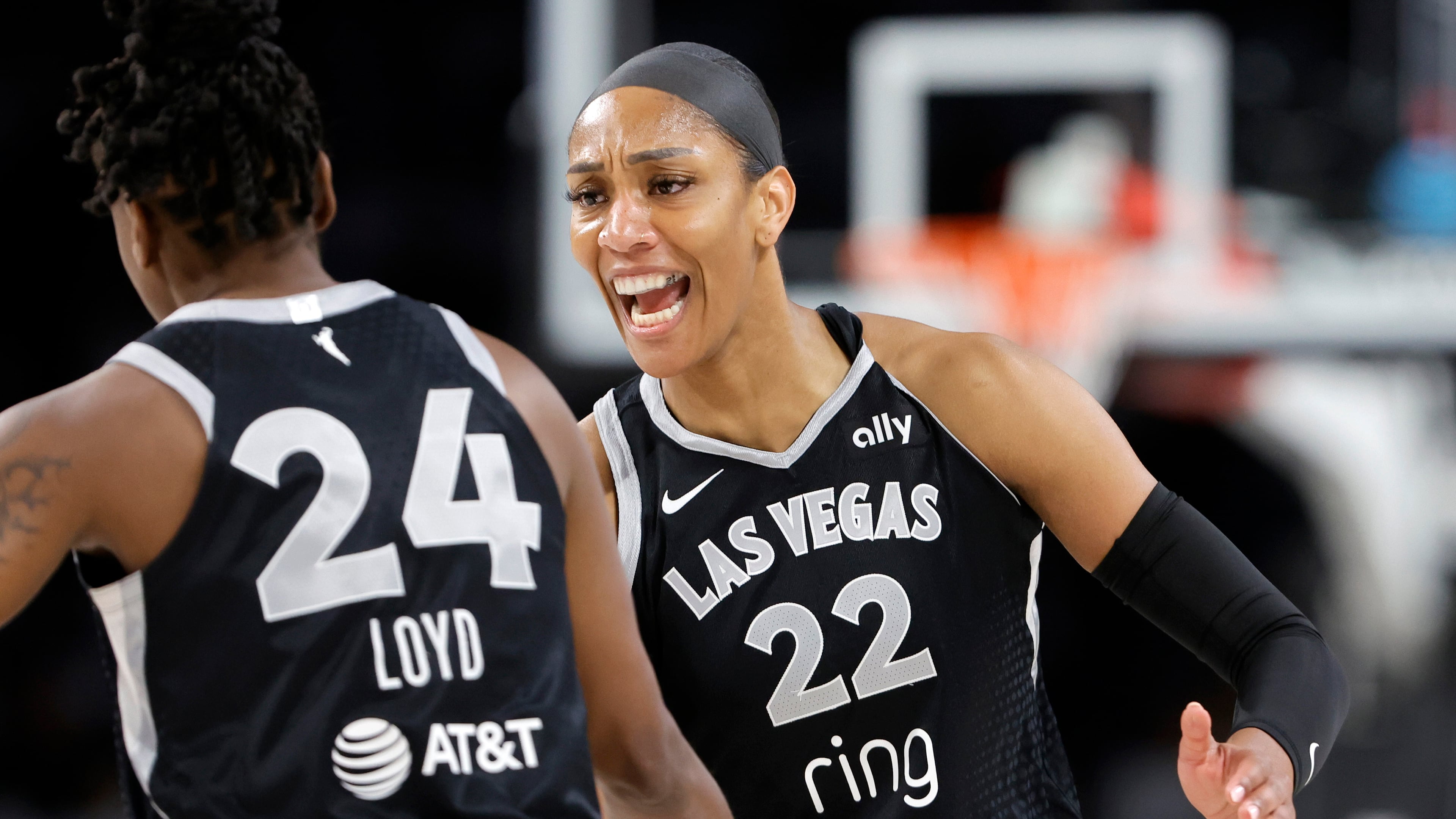 Las Vegas Aces center A'ja Wilson (22) congratulates guard Jewell Loyd (24) after Loyd scored a 3-point basket during the first half of Game 1 against the Seattle Storm in the first round of the WNBA basketball playoffs Sunday, Sept. 14, 2025, in Las Vegas. (AP Photo/Steve Marcus)