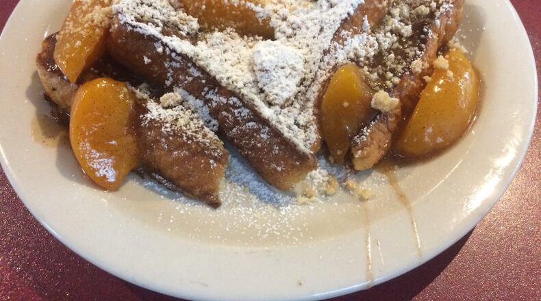 The peach cobbler French toast at Atlanta Breakfast Club is made with two of Georgia’s most famous ingredients: Peaches are cooked in a brown-butter sauce with a shot of Coca-Cola. CONTRIBUTED BY WENDELL BROCK