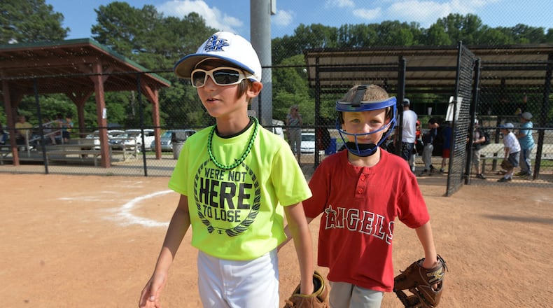 Gabi Yulo (left) and Jack Borse walk back onto a field at Medlock Park in the Decatur area.