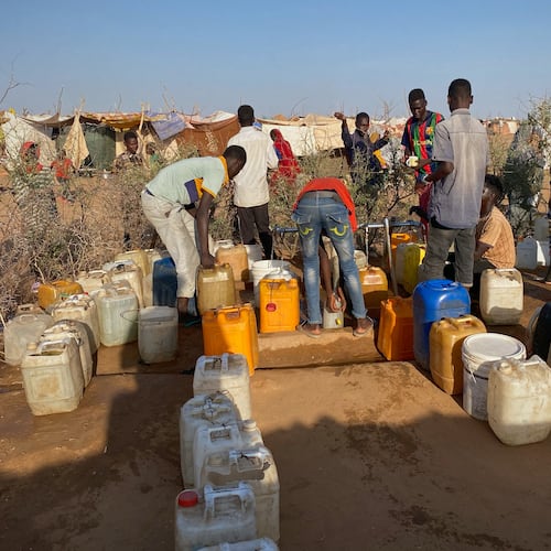 Sudanese men who fled el-Fasher city, after Sudan's paramilitary forces killed hundreds of people in the western Darfur region, collect water at a camp in Tawila, Sudan, Saturday, Nov. 1, 2025. (AP Photo/Mohammed Bakry)