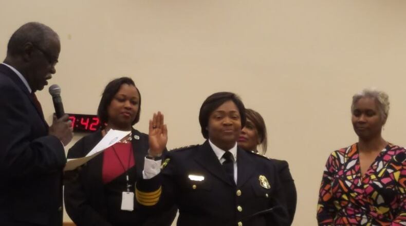 Sheila Rogers, center, is sworn in as interim police chief in South Fulton by mayor Bill Edwards, left, while members of city council look on. ARIELLE KASS/AKASS@AJC.COM