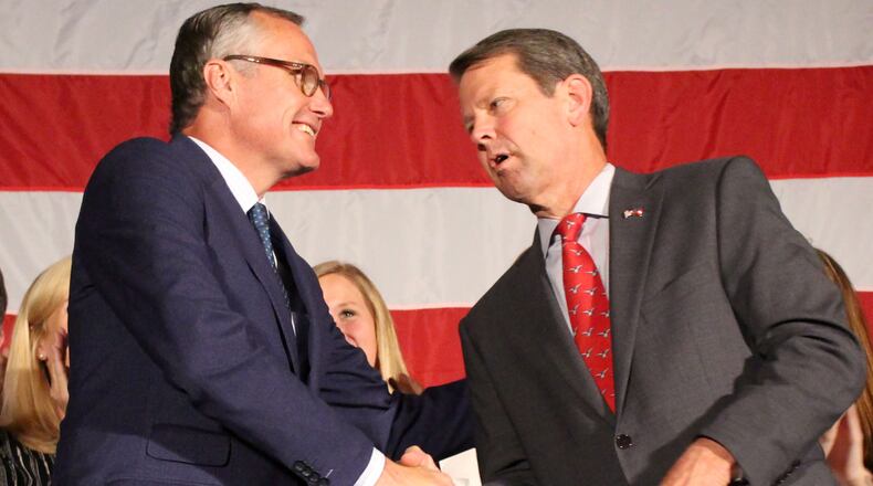 Lt. Gov. Casey Cagle shakes hands with Republican nominee for Georgia Governor Brian Kemp, left to right, after Kemp won the runoff for governor at Hilton Atlanta Northeast on Thursday, July 26 at a Republican Unity Rally. Jenna Eason / Jenna.Eason@coxinc.com