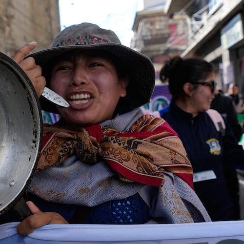 A teacher holds an empty pot during an anti-government protest in La Paz, Bolivia, Tuesday, Sept. 15, 2026. (AP Photo/Juan Karita)