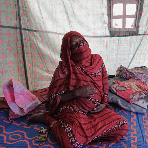 Nadra Mohamed Ahmed, 21, reacts during an interview with The Associated Press inside her tent at the newly established El-Afadh camp in Al Dabbah, Sudan's northern state, Monday, Nov. 17, 2025. (AP Photo/Marwan Ali)