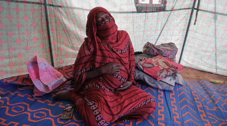 Nadra Mohamed Ahmed, 21, reacts during an interview with The Associated Press inside her tent at the newly established El-Afadh camp in Al Dabbah, Sudan's northern state, Monday, Nov. 17, 2025. (AP Photo/Marwan Ali)