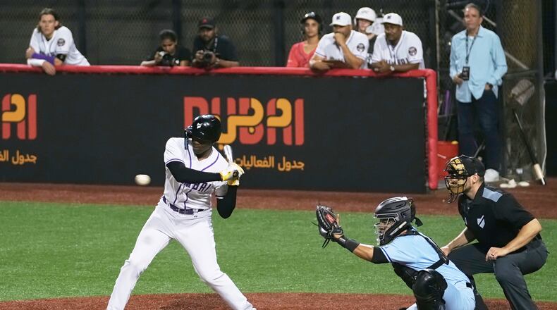 A Mumbai batter hits the ball during the league's opening baseball game against Karachi at the new Barry Larkin Field in Ud al-Bayda on the outskirts of Dubai, United Arab Emirates, Friday, Nov. 14, 2025. (AP Photo/Fatima Shbair)