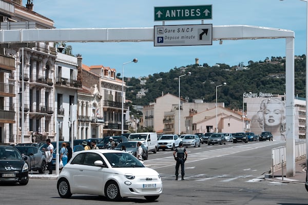Police direct traffic during an electricity outage in Cannes, southern France, Saturday, May 24, 2025. (Photo by Lewis Joly/Invision/AP)