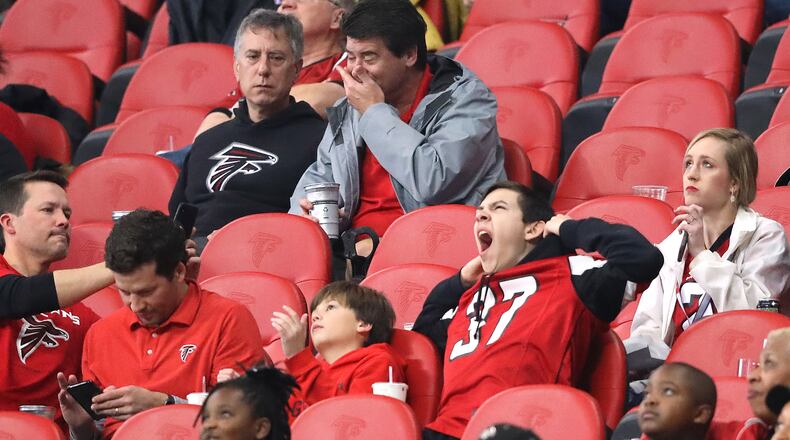 There are plenty of empty seats in Mercedes-Benz Stadium and several fans appear disinterested while the Atlanta Falcons beat the Jacksonville Jaguars 24-12 Sunday, Dec. 22, 2019, in Atlanta.