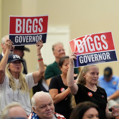 Supporters of Rep. Andy Biggs, R-Ariz., who is running in the primary for Arizona governor, listen to speakers at a campaign event, Friday, July 17, 2026, in Gilbert, Ariz. (AP Photo/Ross D. Franklin)