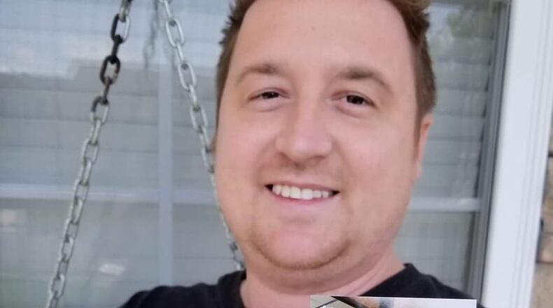 Steve WInfree holds up the special card his wife had made to announce he would be receiving her kidney for a transplant operation.