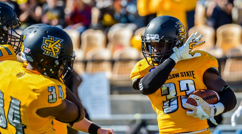 Running back Darnell Holland (33) celebrates his touchdown with freshman Christian Ford (34) against Clark Atlanta, Saturday, Nov. 5, 2016. (Cory Hancock for the AJC)