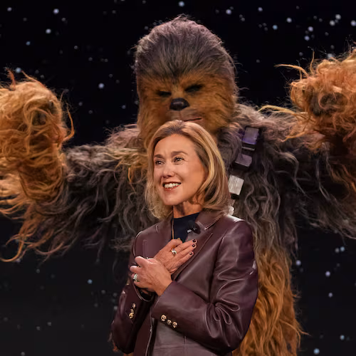 LEGO chief product and marketing officer and executive vice president Julia Goldin talks as a a Chewbacca stands behind her during an LEGO news conference ahead of the CES tech show Monday, Jan. 5, 2026, in Las Vegas. (AP Photo/Abbie Parr)