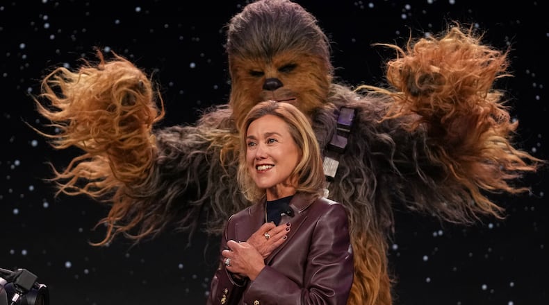 LEGO chief product and marketing officer and executive vice president Julia Goldin talks as a a Chewbacca stands behind her during an LEGO news conference ahead of the CES tech show Monday, Jan. 5, 2026, in Las Vegas. (AP Photo/Abbie Parr)